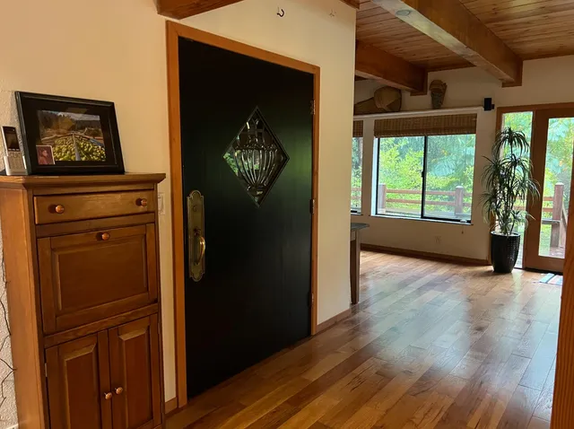 a view of an entryway with wooden floor