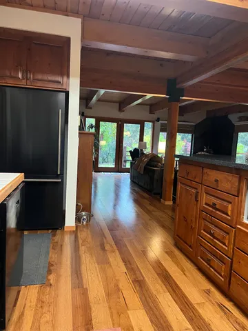 a view of a living room with wooden floor