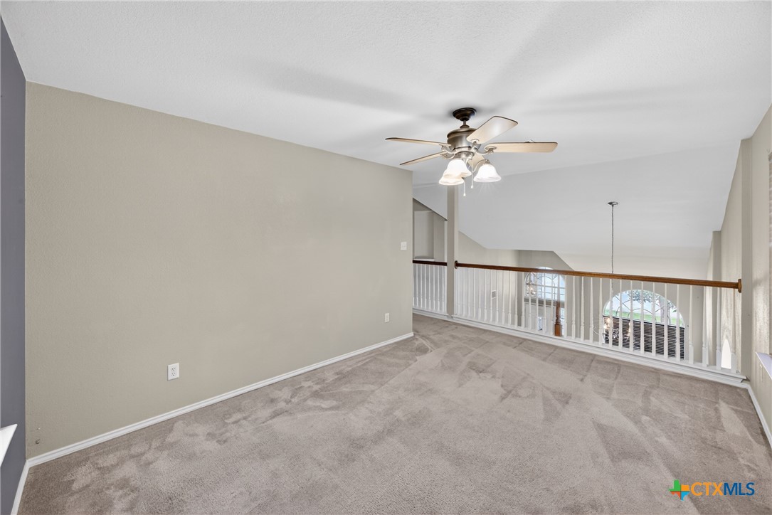 7015 Rickey Drive Temple, TX 76502 - Photo 25 of 29 an empty room with chandelier fan