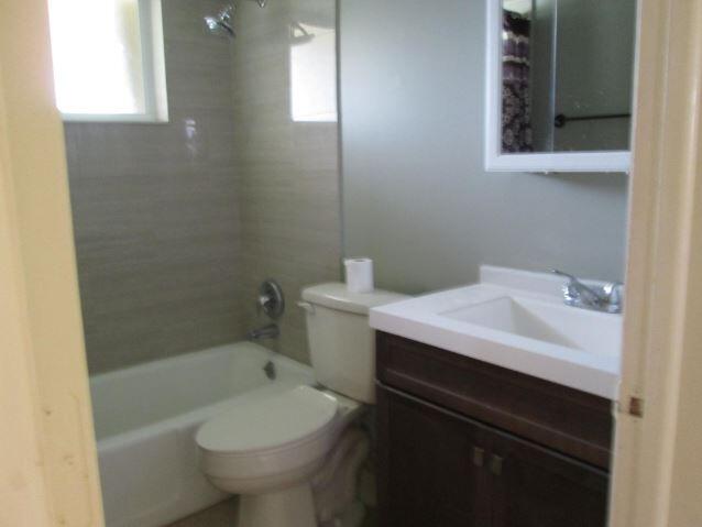 1911 Northeast 27th Court, Unit 13 Lighthouse Point, FL 33064 - Photo 41 of 61 a bathroom with a sink toilet and shower