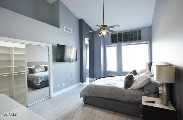 a bedroom with a bed and a chandelier