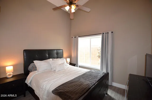 a bedroom with a bed and a window