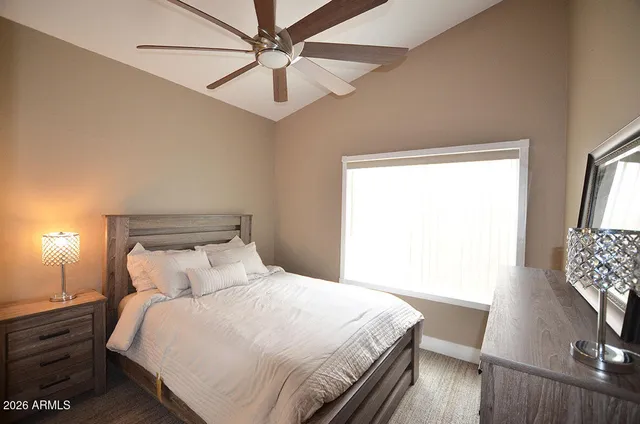 a bedroom with a large bed and a window