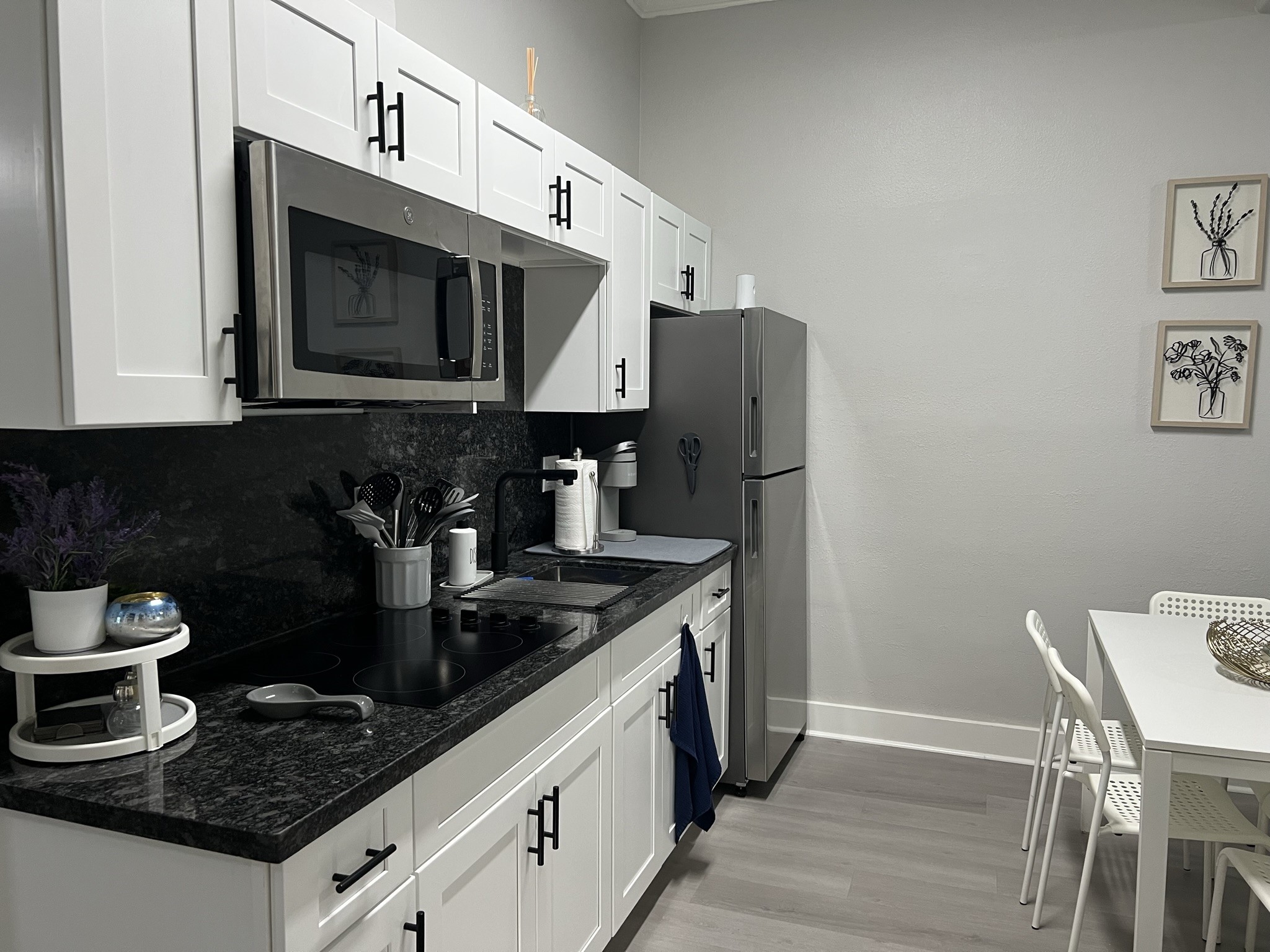 220 Redan Street, Unit A Houston, TX 77009 - Photo 9 of 22 a kitchen with stainless steel appliances granite countertop a stove a microwave a sink and a refrigerator