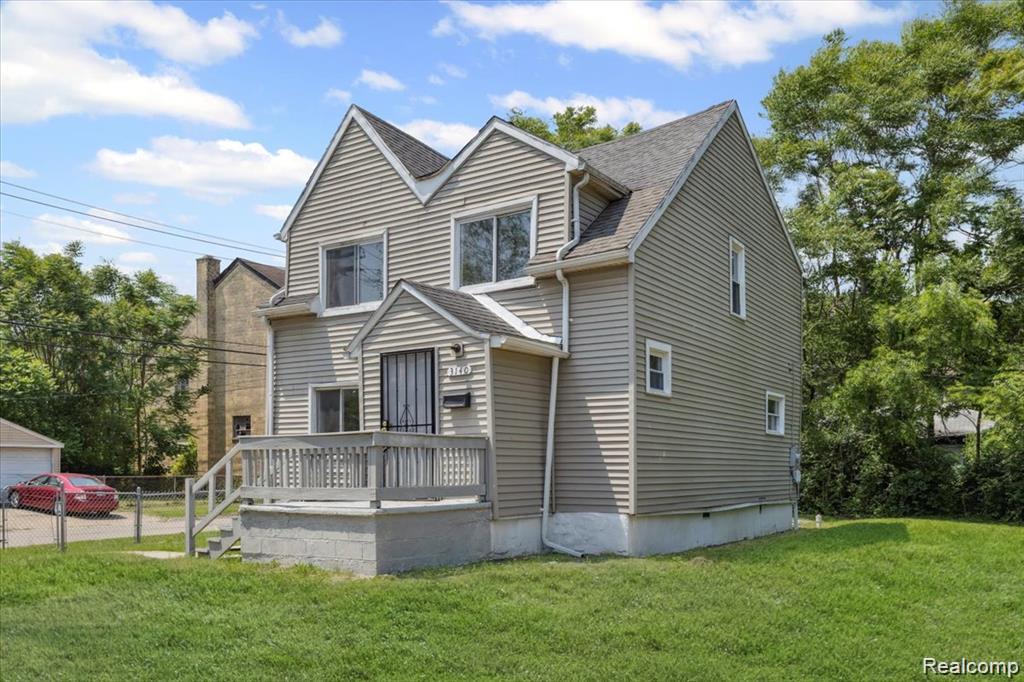 3140 Moore Street Inkster, MI 48141 - Photo 2 of 18 Two-story residence featuring light-colored horizontal siding and a front porch with a wood railing