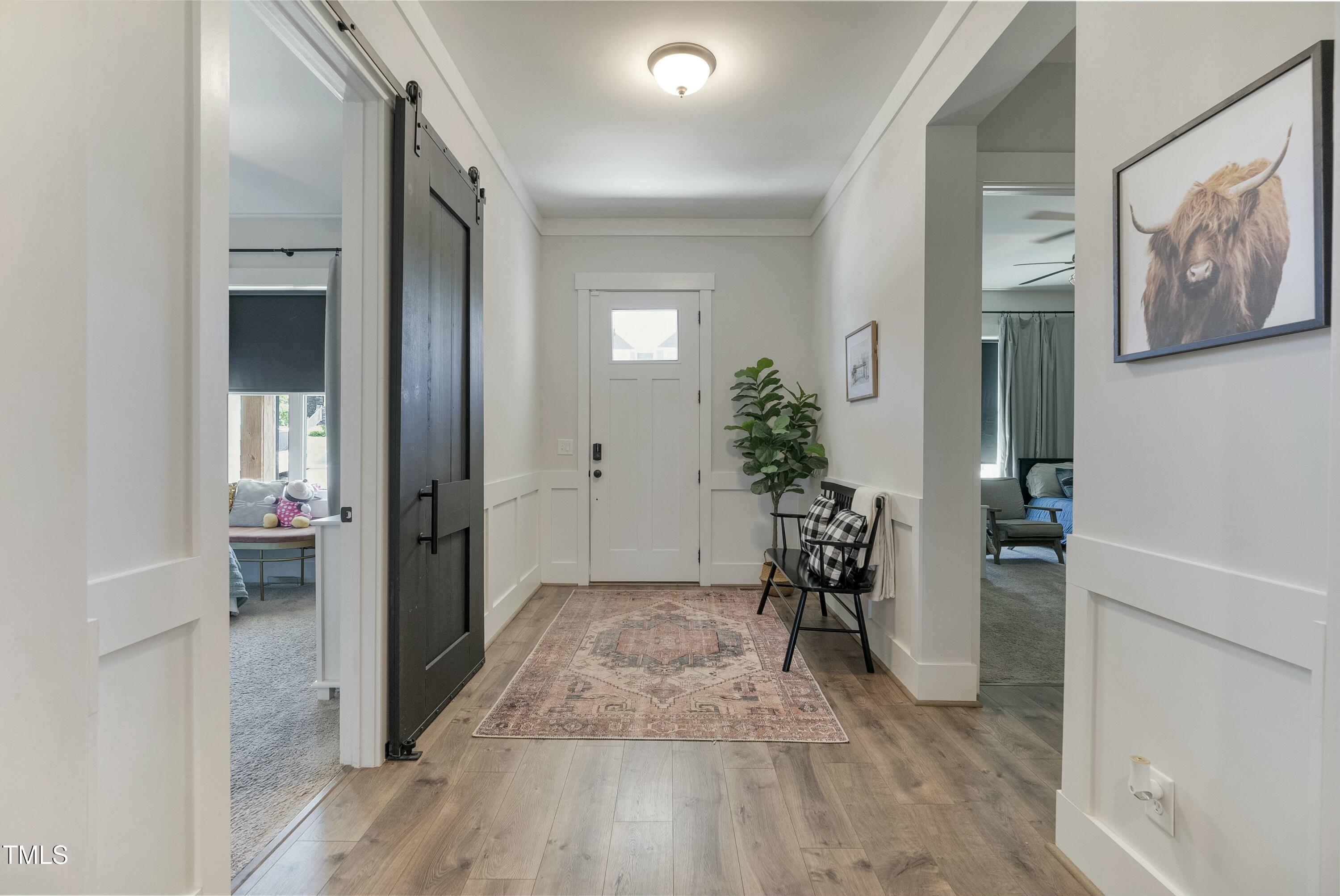 512 Adkins Ridge Road Rolesville, NC 27571 - Photo 13 of 53 a view of a hallway with wooden floor and furniture