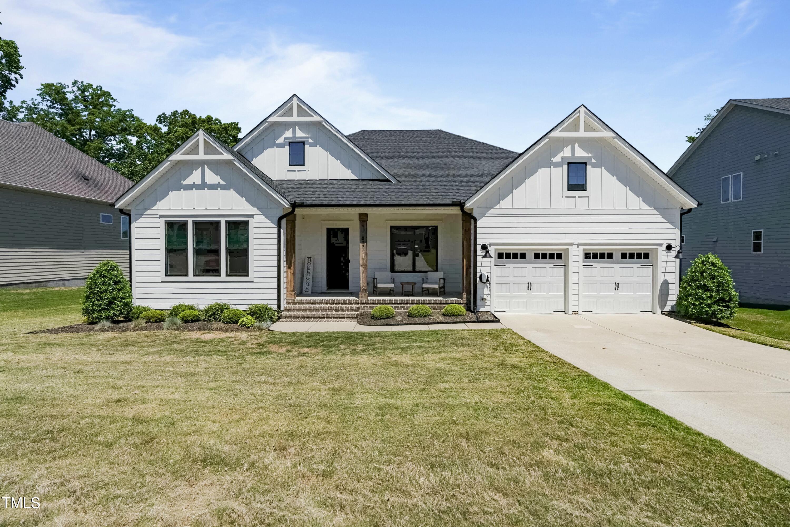 512 Adkins Ridge Road Rolesville, NC 27571 - Photo 2 of 53 a front view of a house with garden