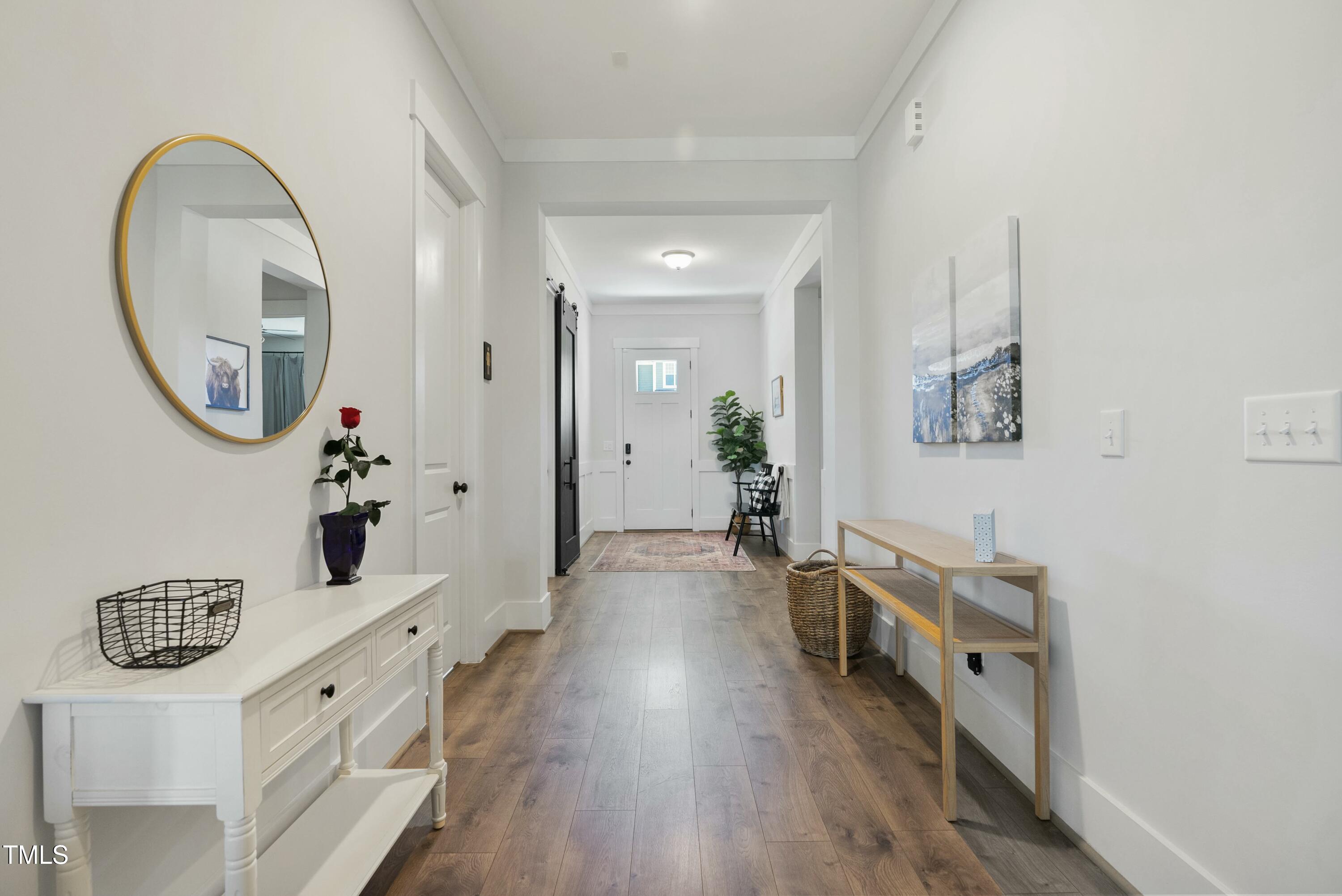 512 Adkins Ridge Road Rolesville, NC 27571 - Photo 24 of 53 wooden floor in a hall with a mirror and a sink