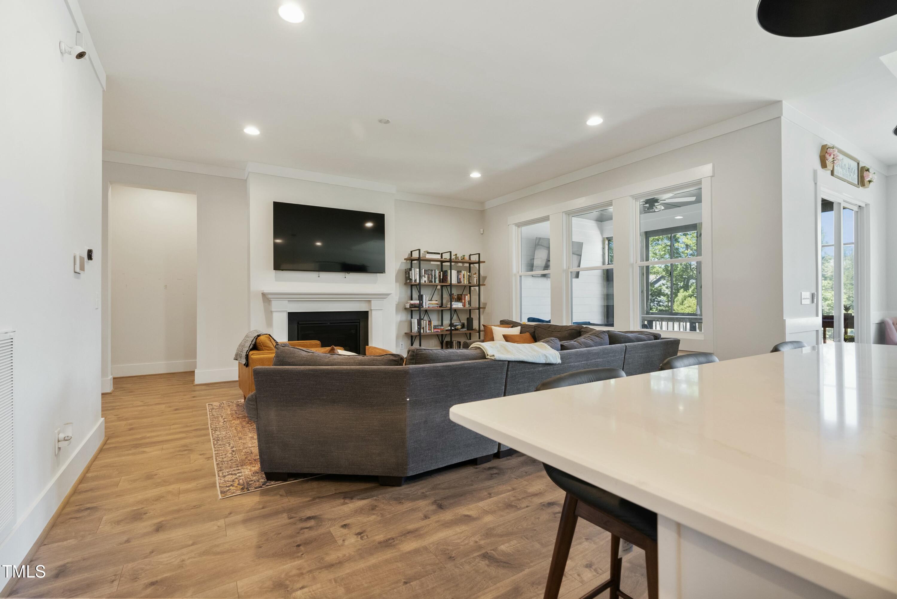 512 Adkins Ridge Road Rolesville, NC 27571 - Photo 26 of 53 a living room with furniture a flat screen tv and a fireplace