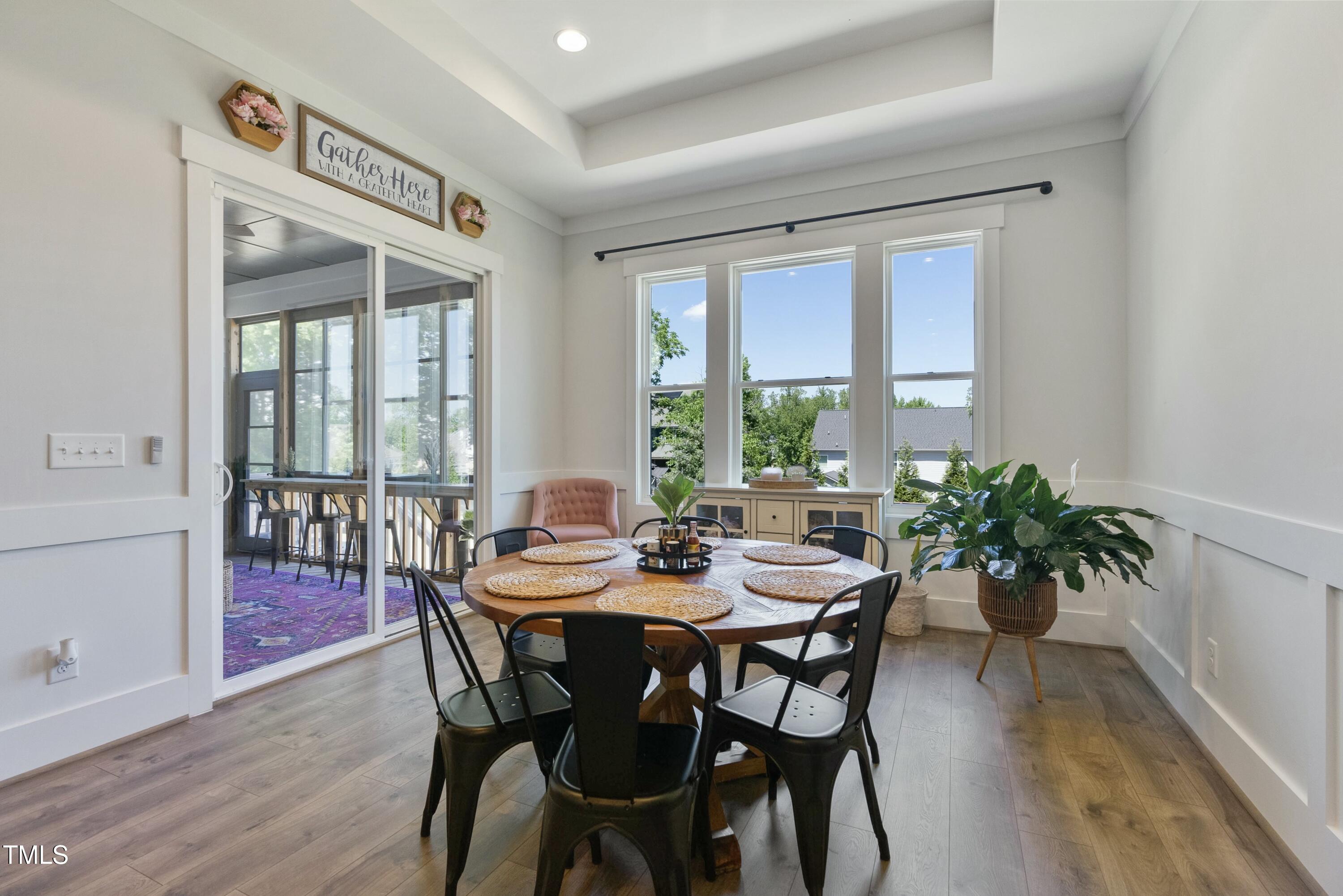 512 Adkins Ridge Road Rolesville, NC 27571 - Photo 27 of 53 a view of a dining room with furniture window and wooden floor