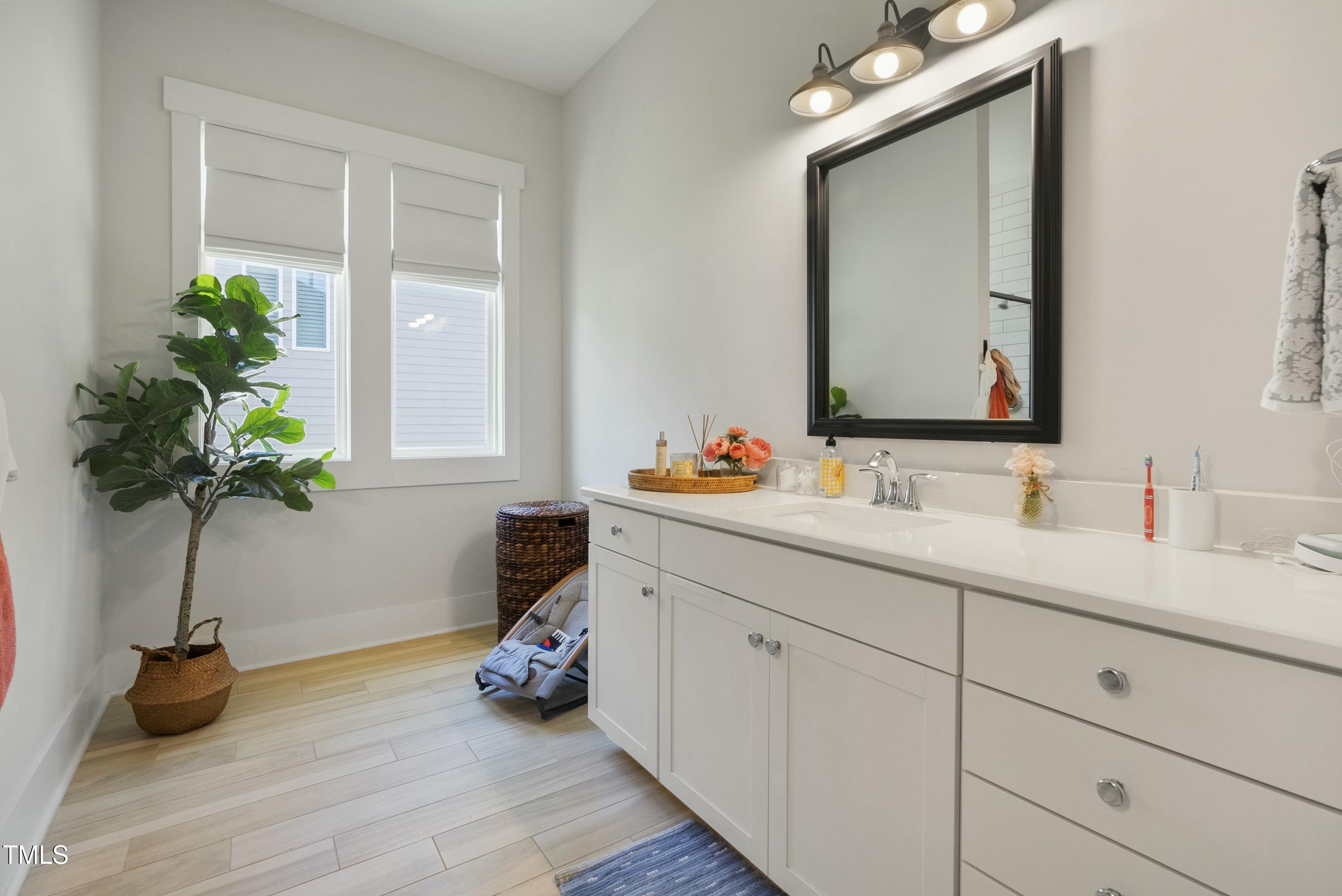 512 Adkins Ridge Road Rolesville, NC 27571 - Photo 29 of 53 a bathroom with a double vanity sink and a mirror