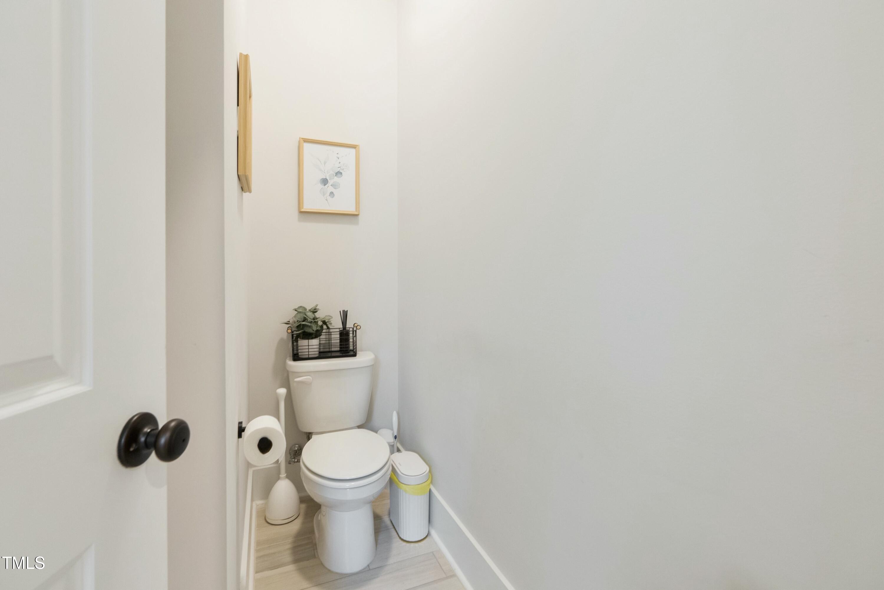 512 Adkins Ridge Road Rolesville, NC 27571 - Photo 30 of 53 a white toilet sitting next to a bathroom sink
