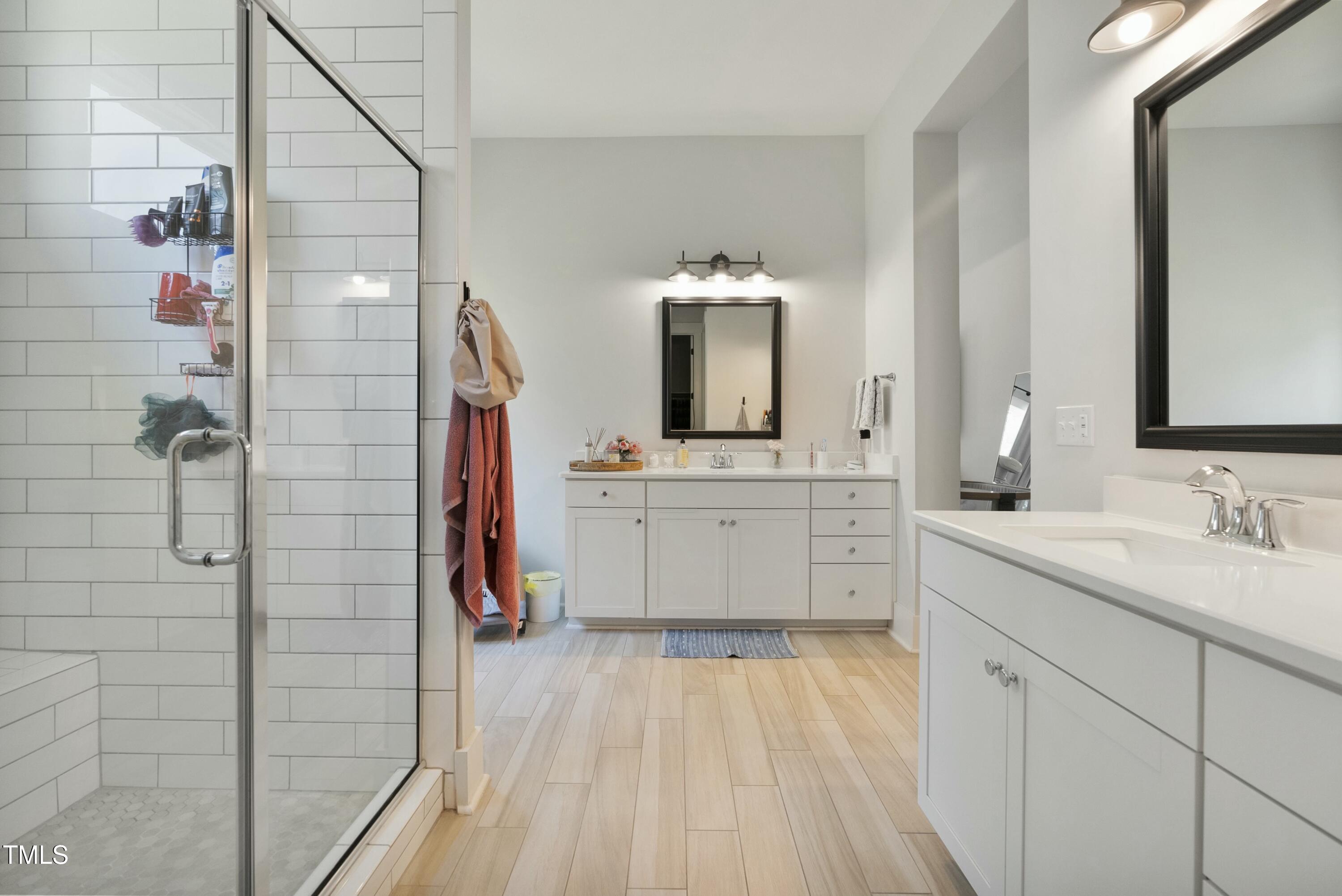512 Adkins Ridge Road Rolesville, NC 27571 - Photo 33 of 53 a bathroom with a double vanity sink mirror and shower