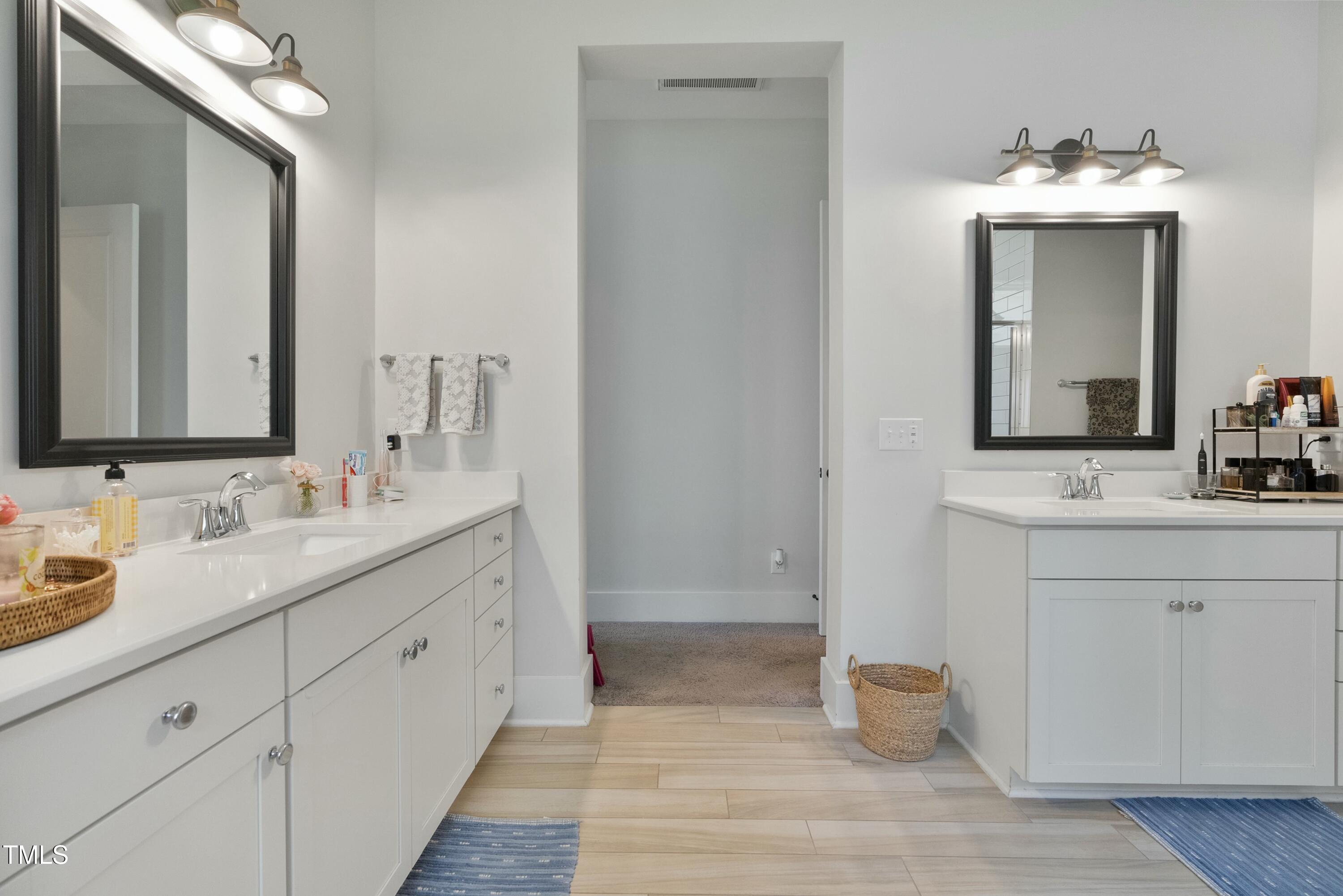 512 Adkins Ridge Road Rolesville, NC 27571 - Photo 34 of 53 a bathroom with 2 sink and a mirror