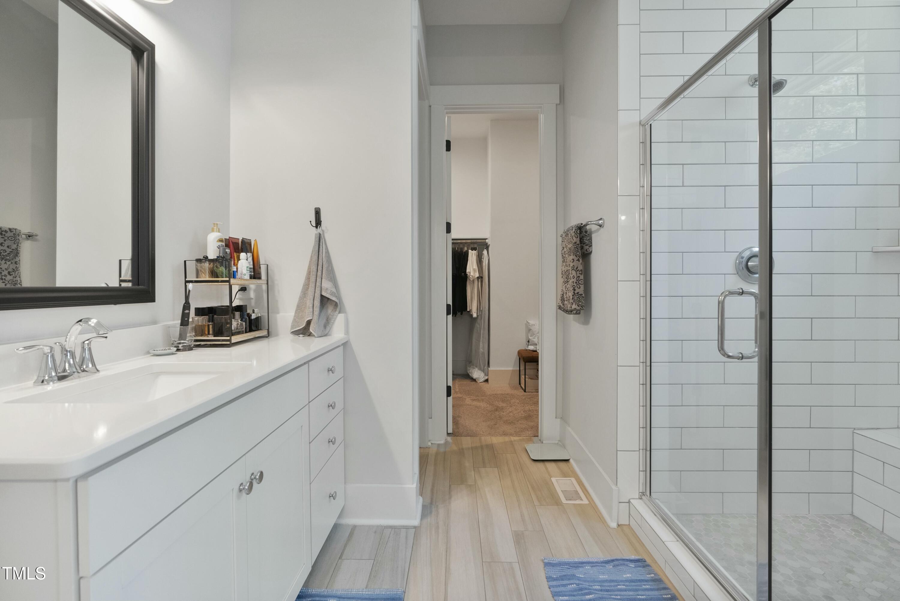 512 Adkins Ridge Road Rolesville, NC 27571 - Photo 35 of 53 a bathroom with a double vanity sink and mirror