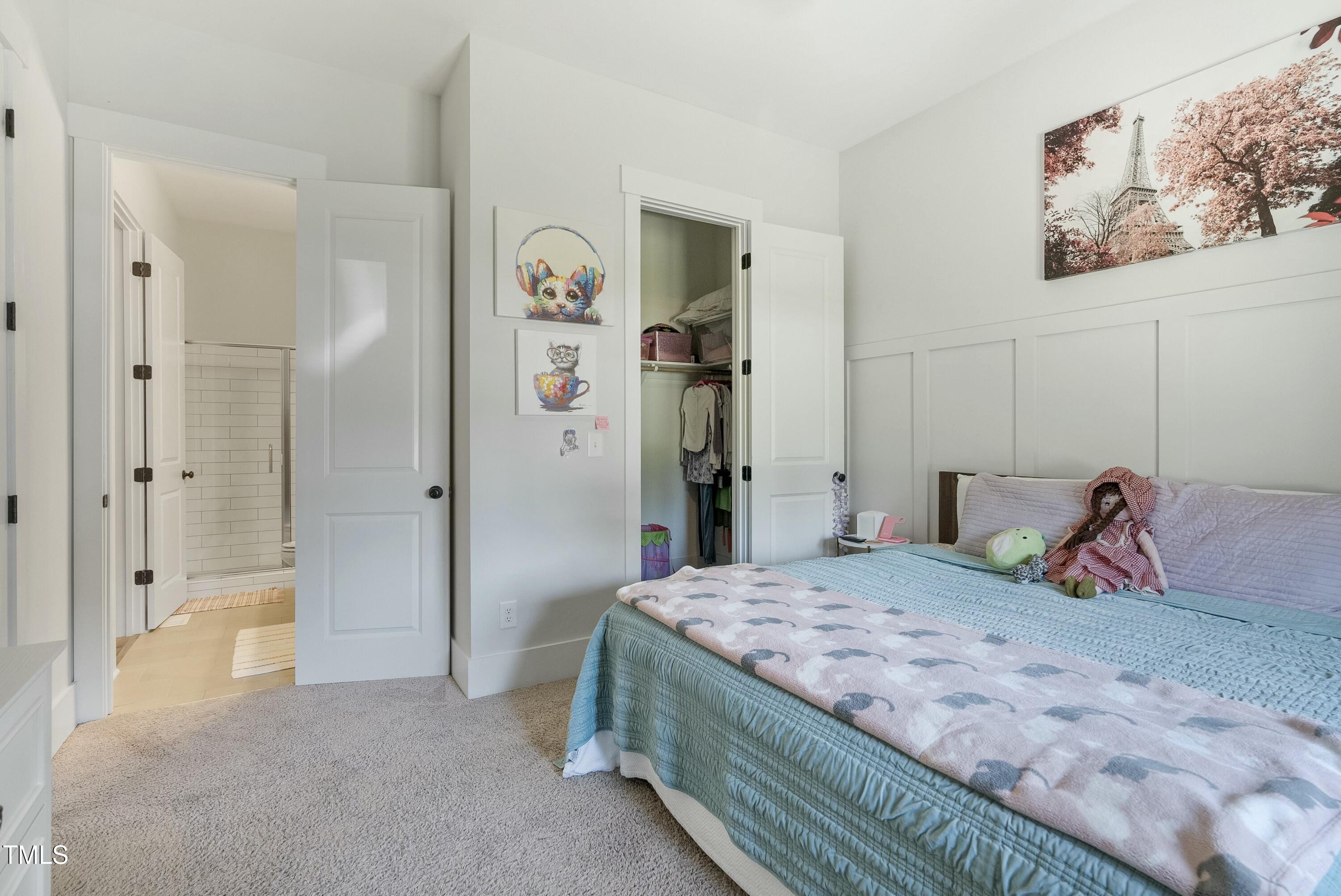 512 Adkins Ridge Road Rolesville, NC 27571 - Photo 36 of 53 a bedroom with a bed and a chandelier