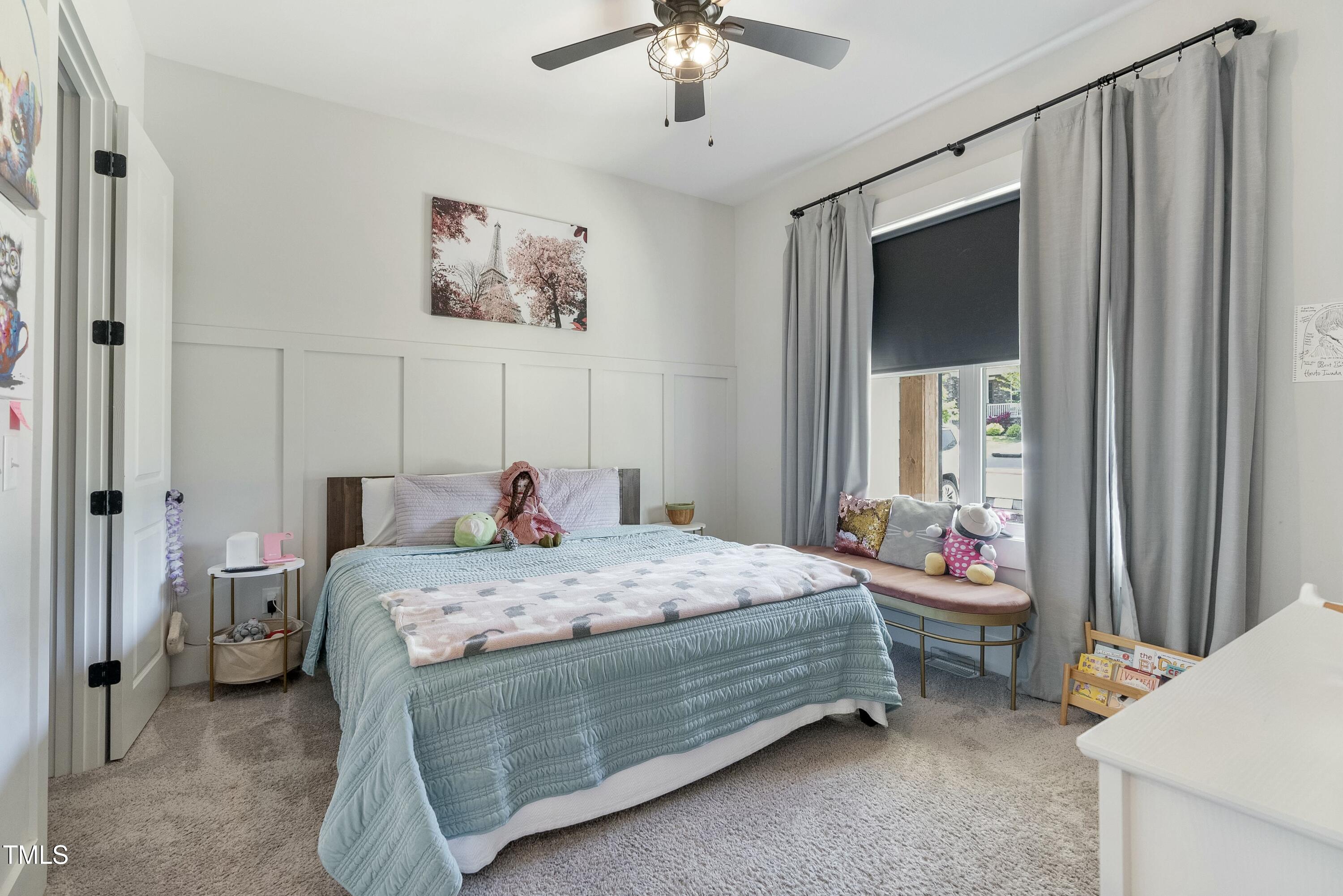 512 Adkins Ridge Road Rolesville, NC 27571 - Photo 37 of 53 a bedroom with a bed and a chandelier