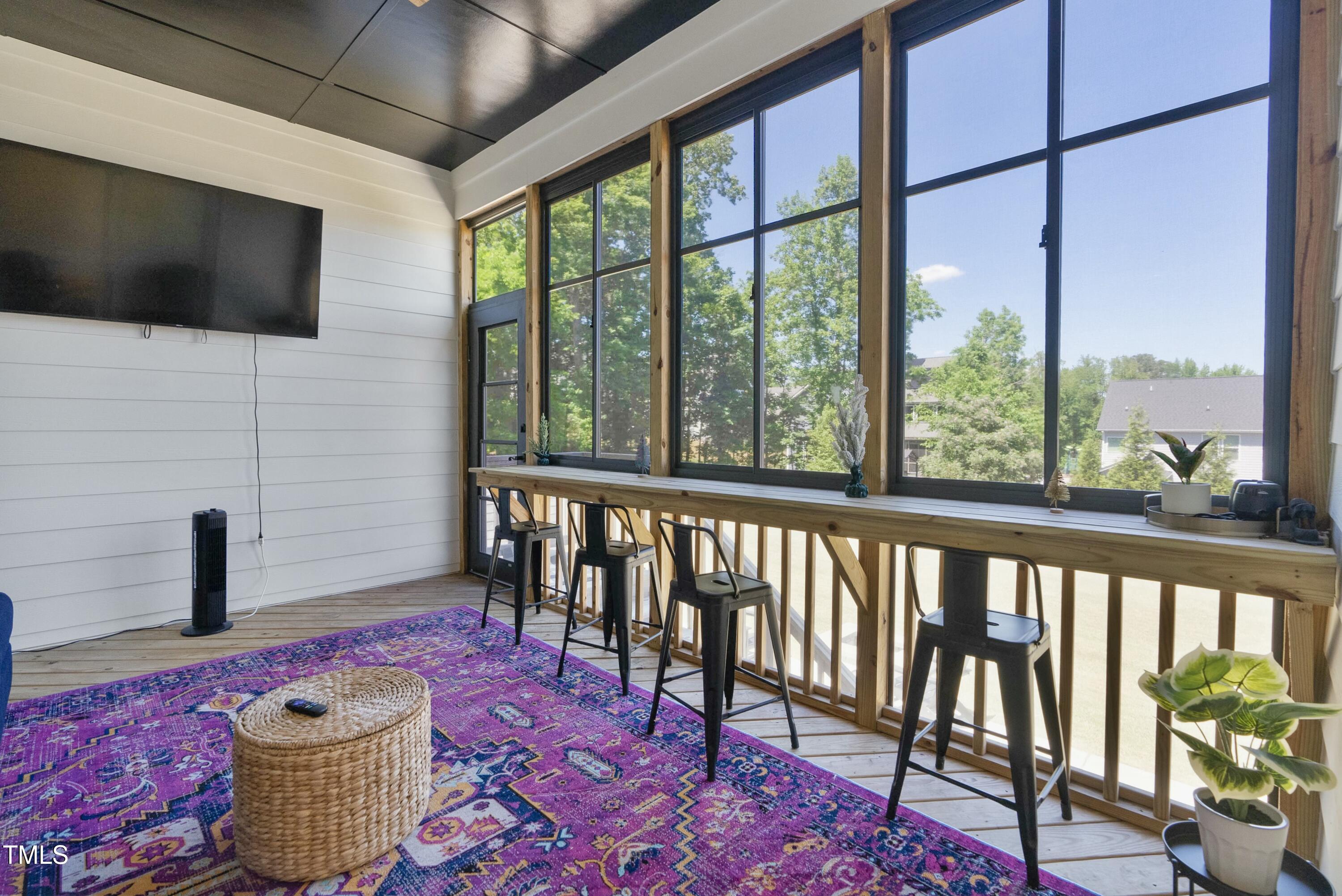 512 Adkins Ridge Road Rolesville, NC 27571 - Photo 40 of 53 a outdoor living space with furniture and a flat screen tv