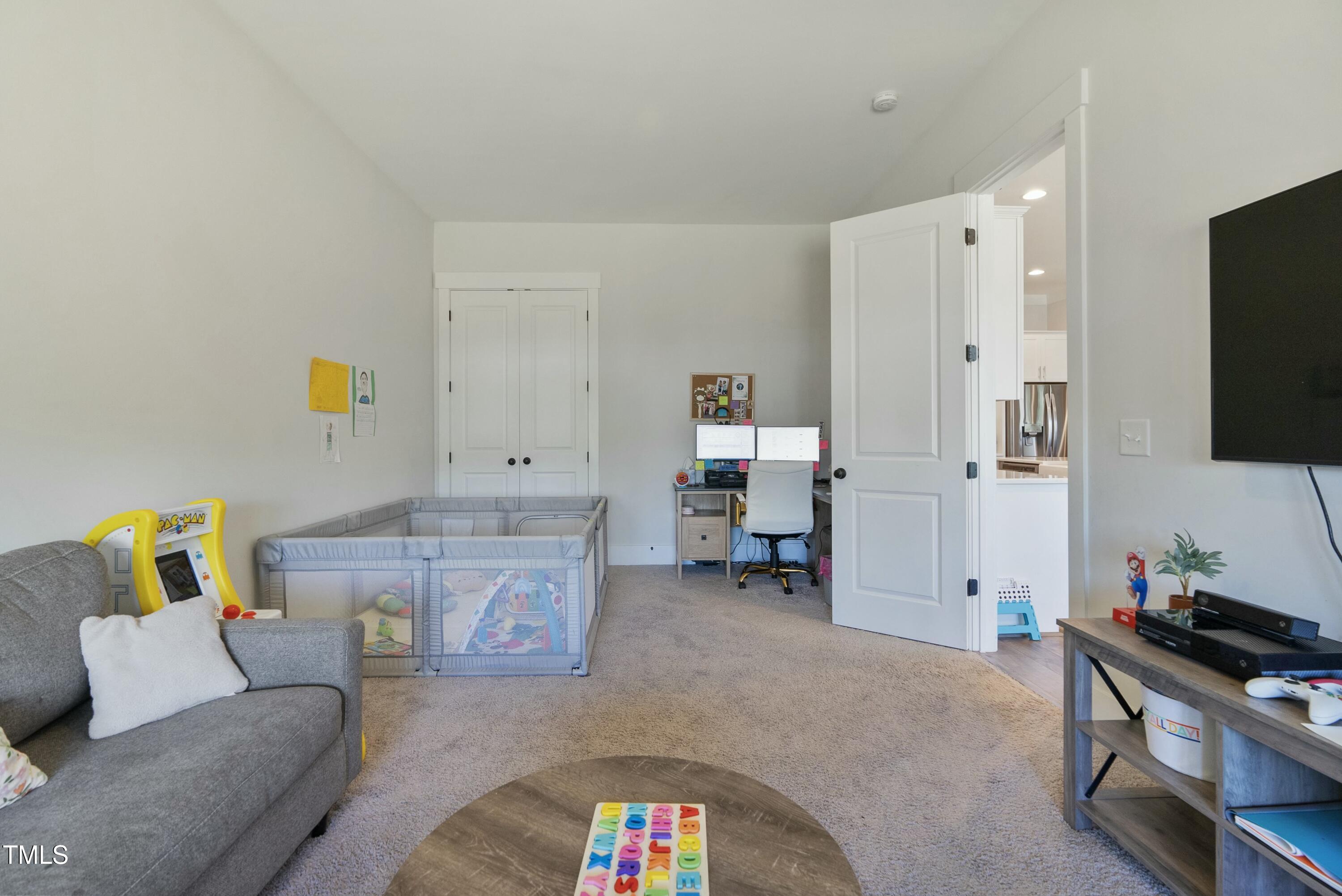 512 Adkins Ridge Road Rolesville, NC 27571 - Photo 41 of 53 a living room with furniture and a flat screen tv