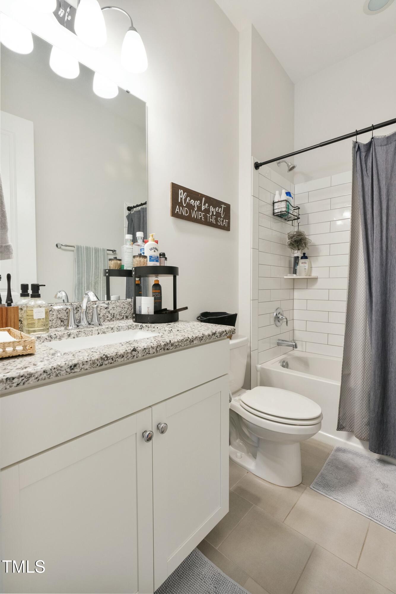 512 Adkins Ridge Road Rolesville, NC 27571 - Photo 44 of 53 a bathroom with a granite countertop toilet sink and mirror