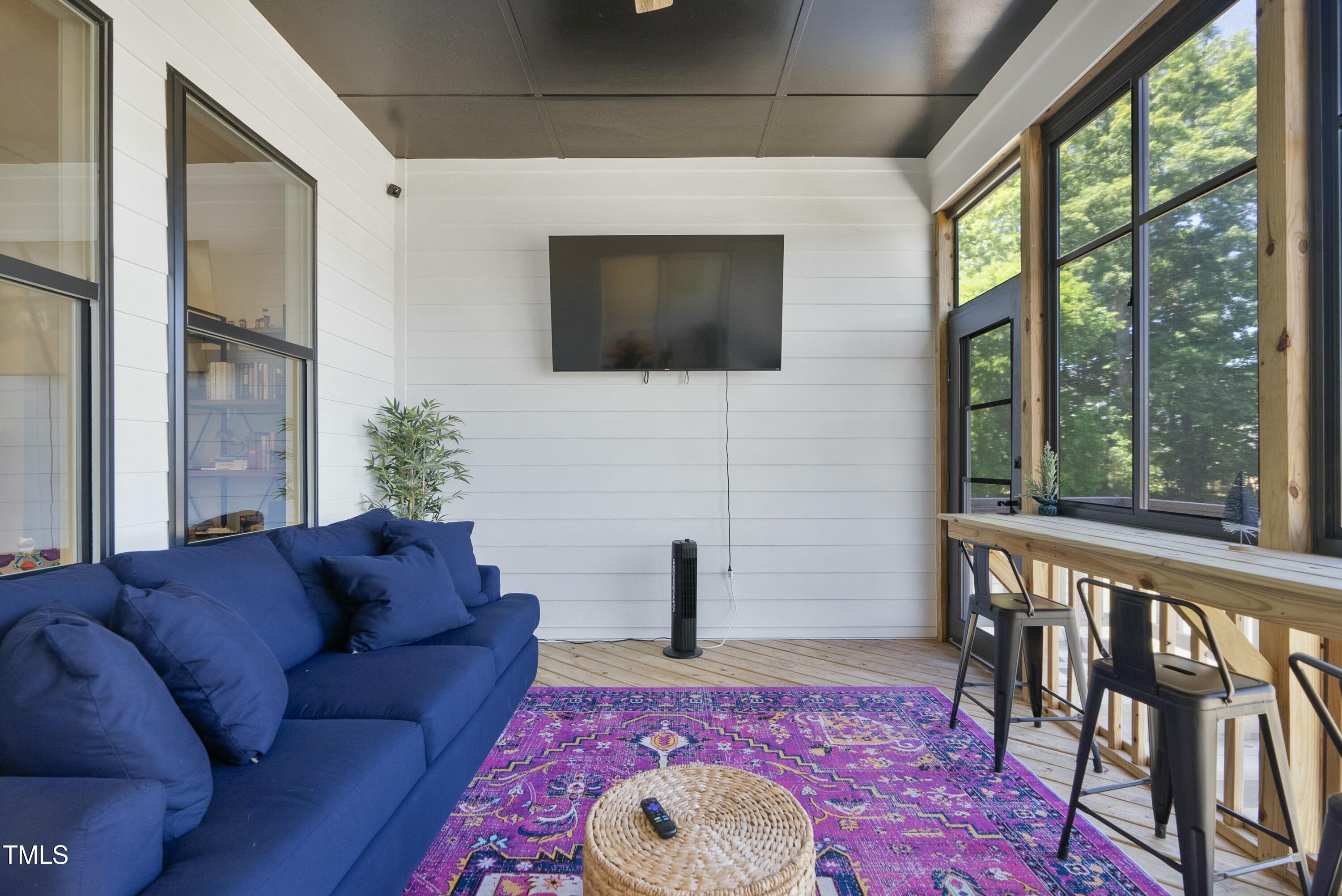 512 Adkins Ridge Road Rolesville, NC 27571 - Photo 46 of 53 a living room with furniture wooden floor and a flat screen tv