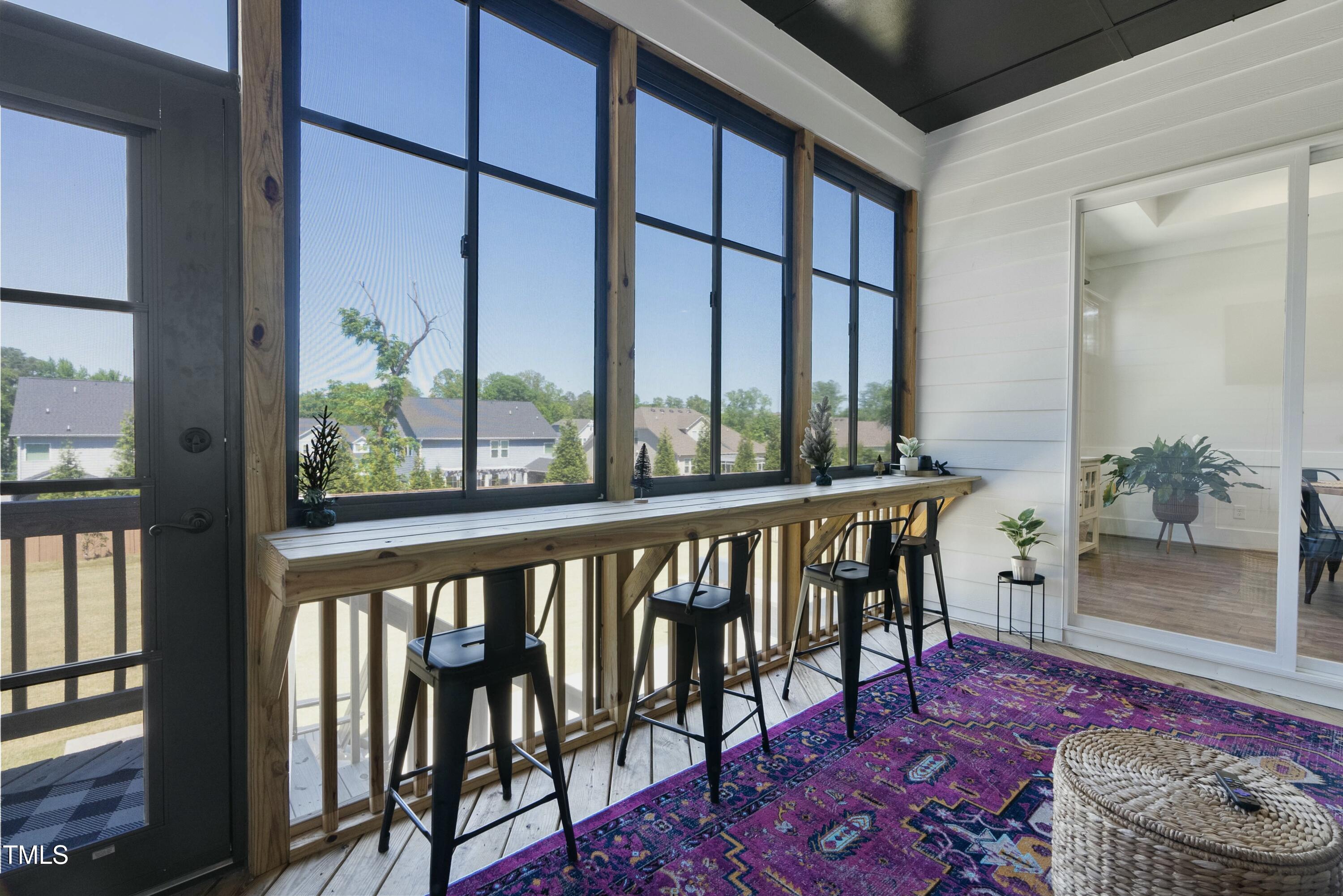512 Adkins Ridge Road Rolesville, NC 27571 - Photo 48 of 53 a view of a balcony with chair and wooden floor