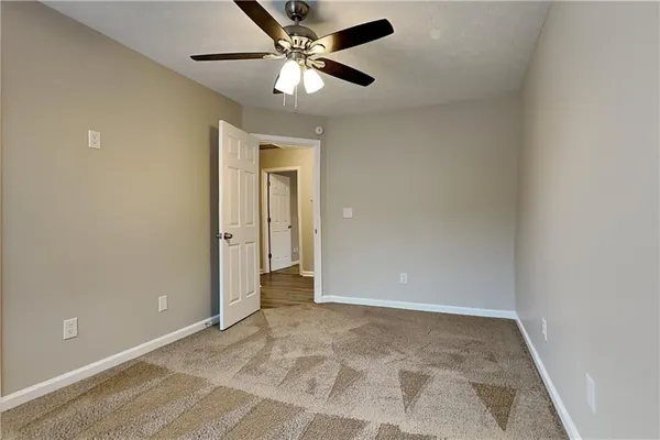an empty room with fan and a ceiling fan