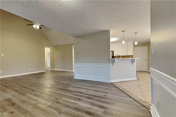 a view of a kitchen with a sink and a refrigerator