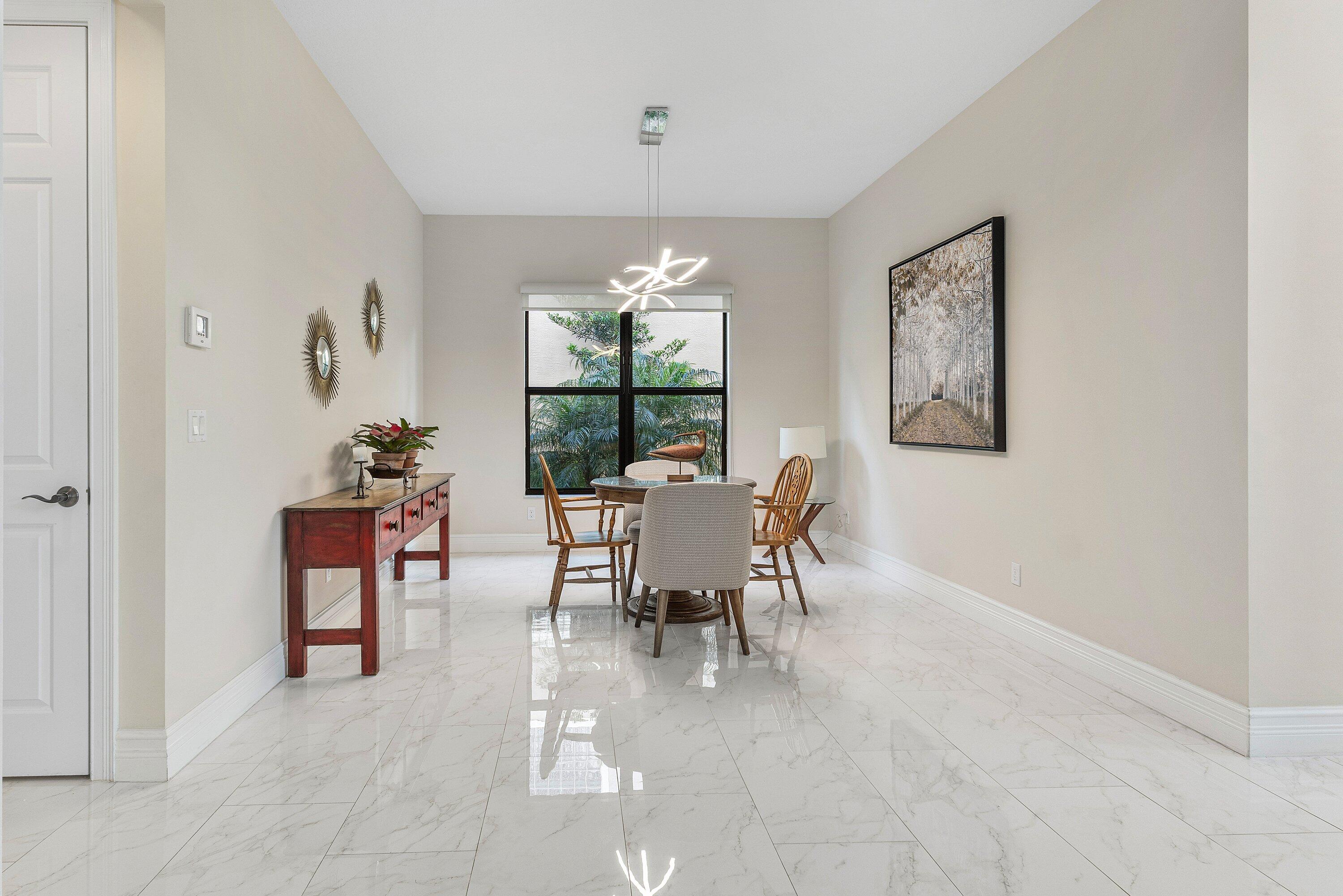 9349 Eden Roc Court Delray Beach, FL 33446 - Photo 11 of 50 a dining room with furniture and window