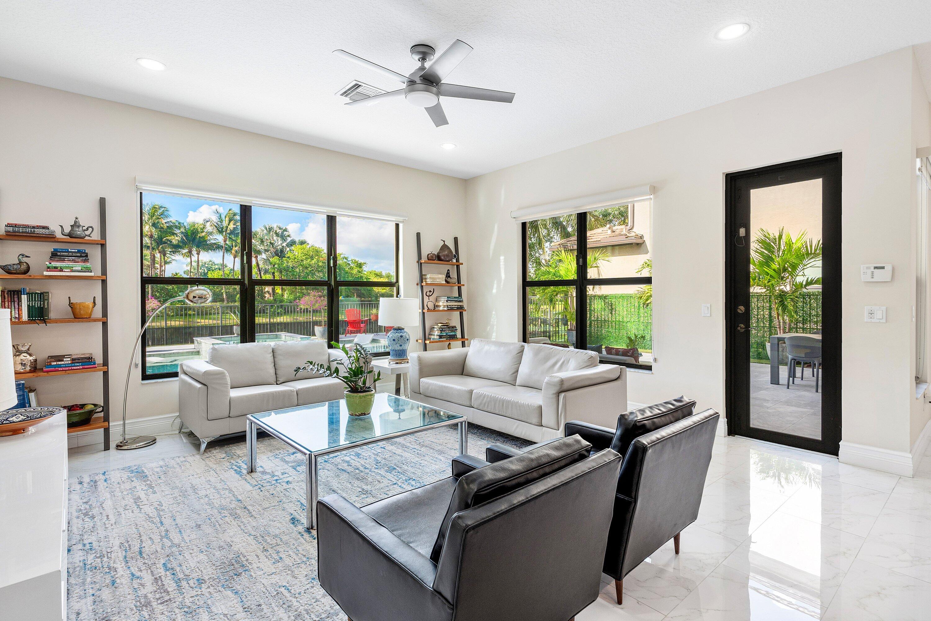 9349 Eden Roc Court Delray Beach, FL 33446 - Photo 13 of 50 a living room with furniture and a large window