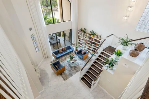 a living room with furniture a rug and a book shelf