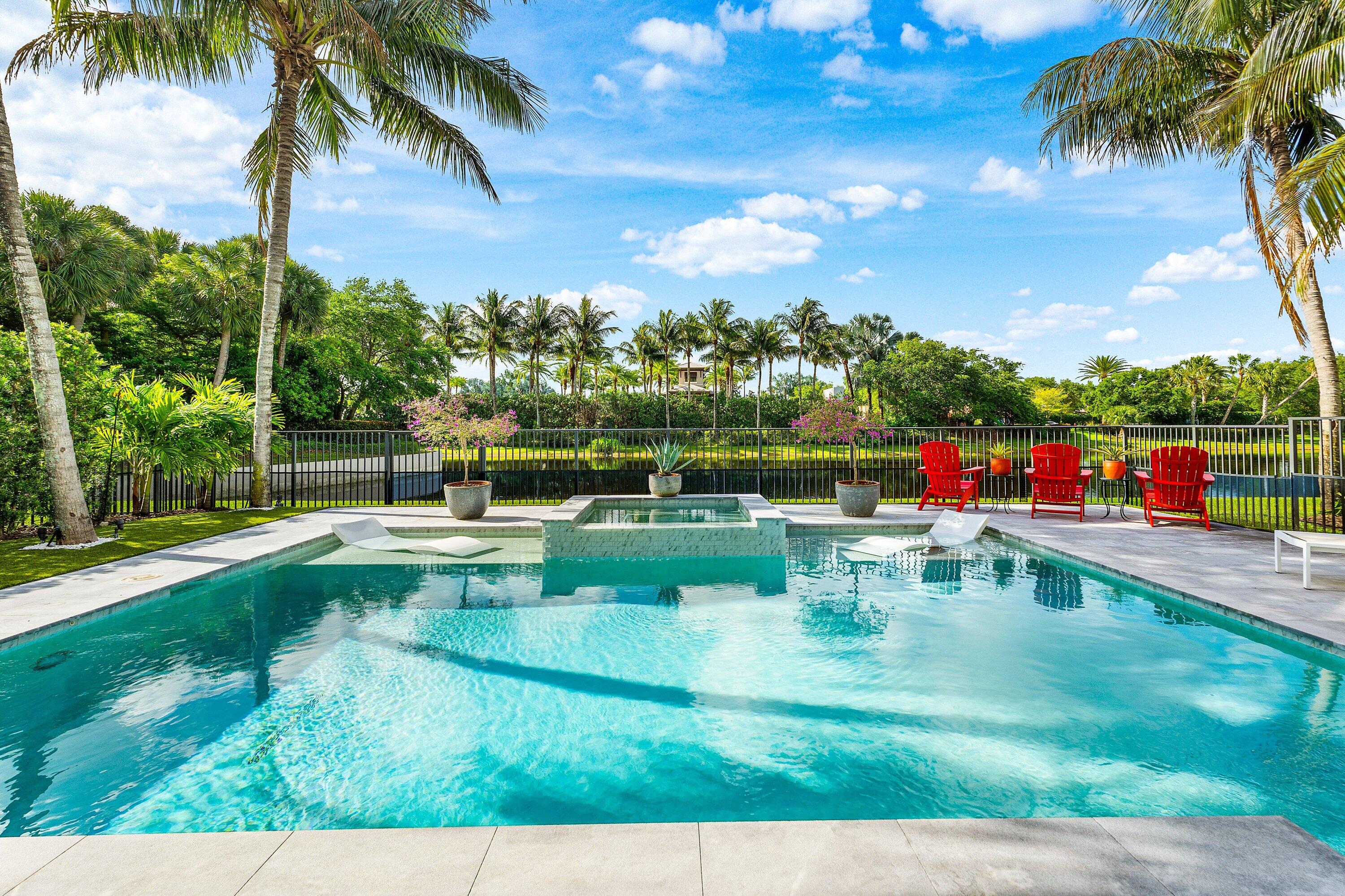 9349 Eden Roc Court Delray Beach, FL 33446 - Photo 2 of 50 a view of swimming pool with a garden and seating