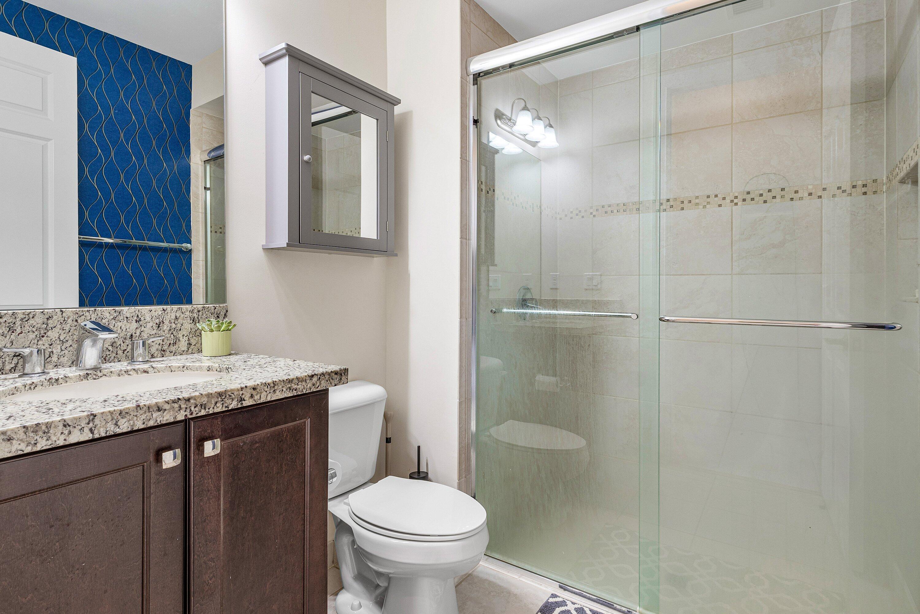 9349 Eden Roc Court Delray Beach, FL 33446 - Photo 23 of 50 a bathroom with a granite countertop sink toilet and shower
