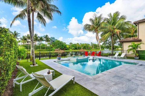 a view of yard with swimming pool and green space