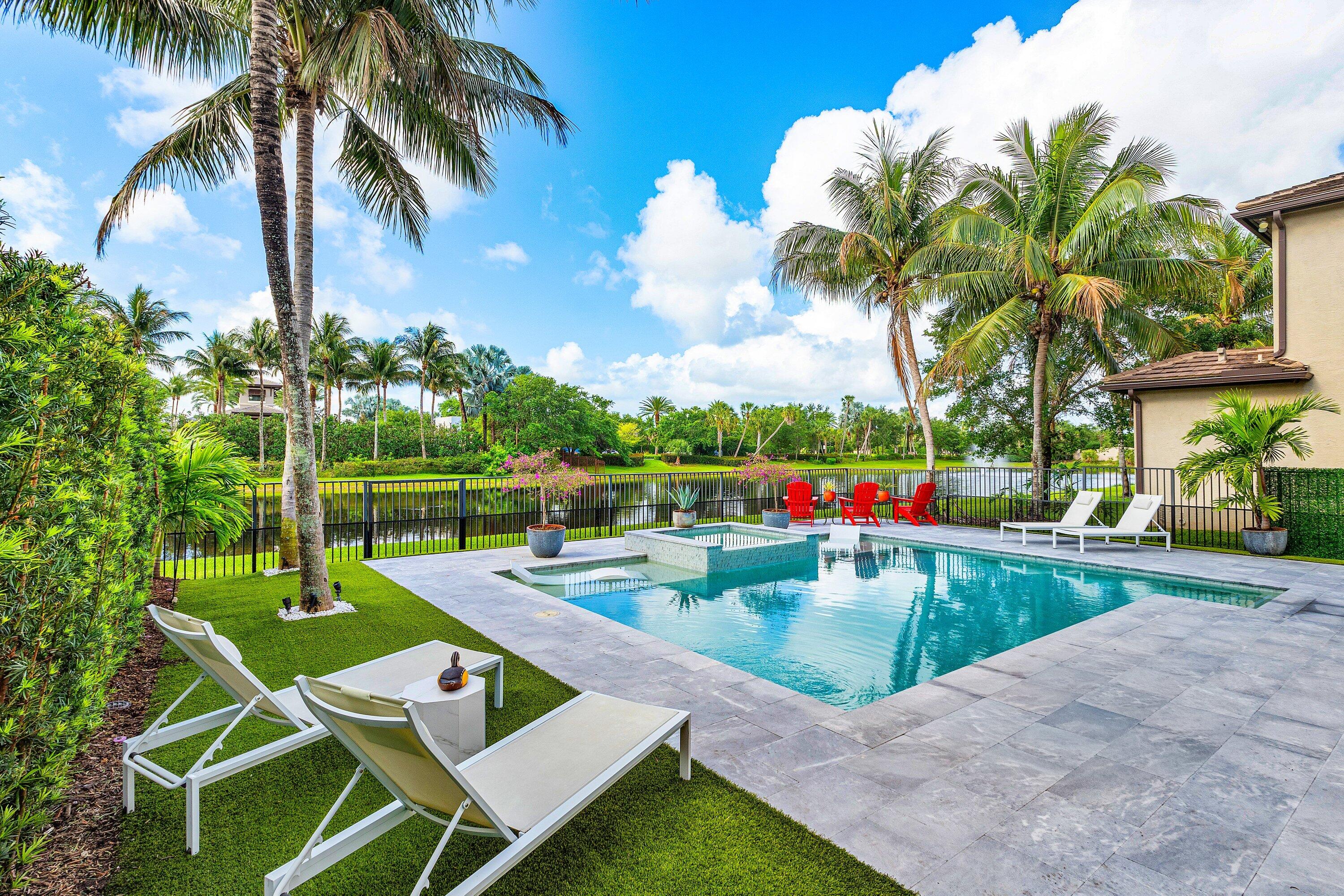 9349 Eden Roc Court Delray Beach, FL 33446 - Photo 3 of 50 a view of yard with swimming pool and green space