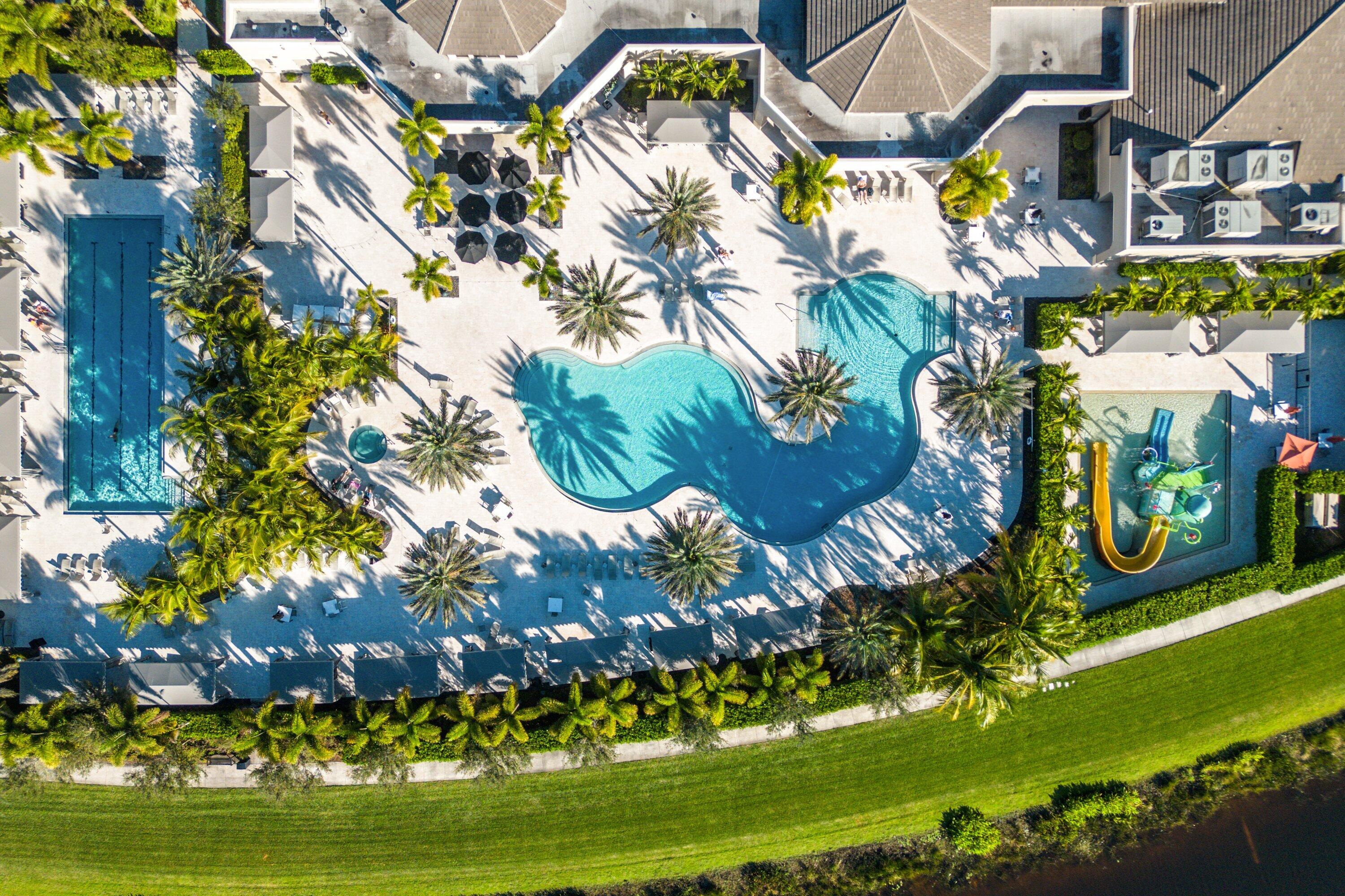 9349 Eden Roc Court Delray Beach, FL 33446 - Photo 32 of 50 a view of swimming pool with a garden