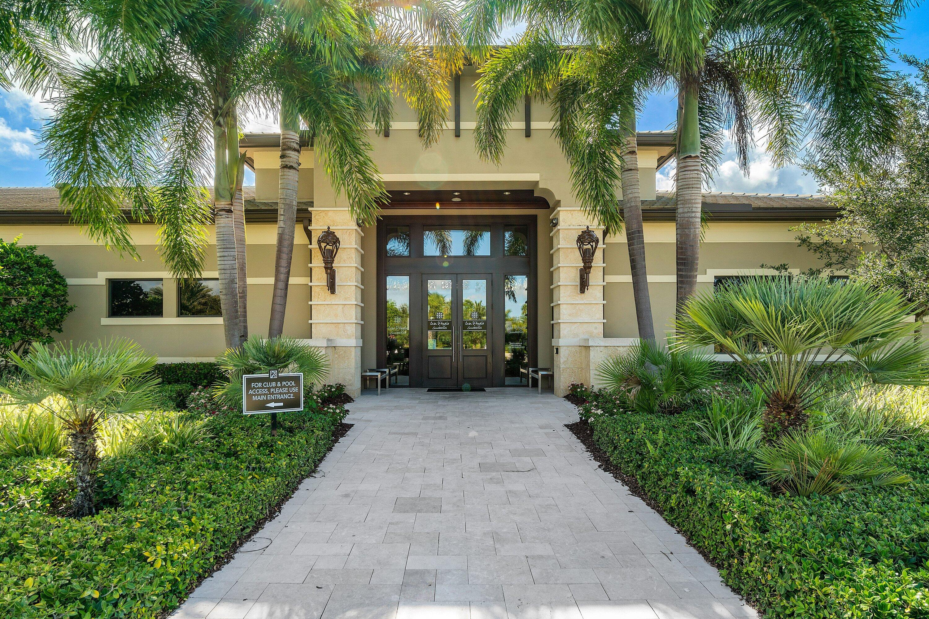 9349 Eden Roc Court Delray Beach, FL 33446 - Photo 34 of 50 front view of a brick house with a yard and potted plants
