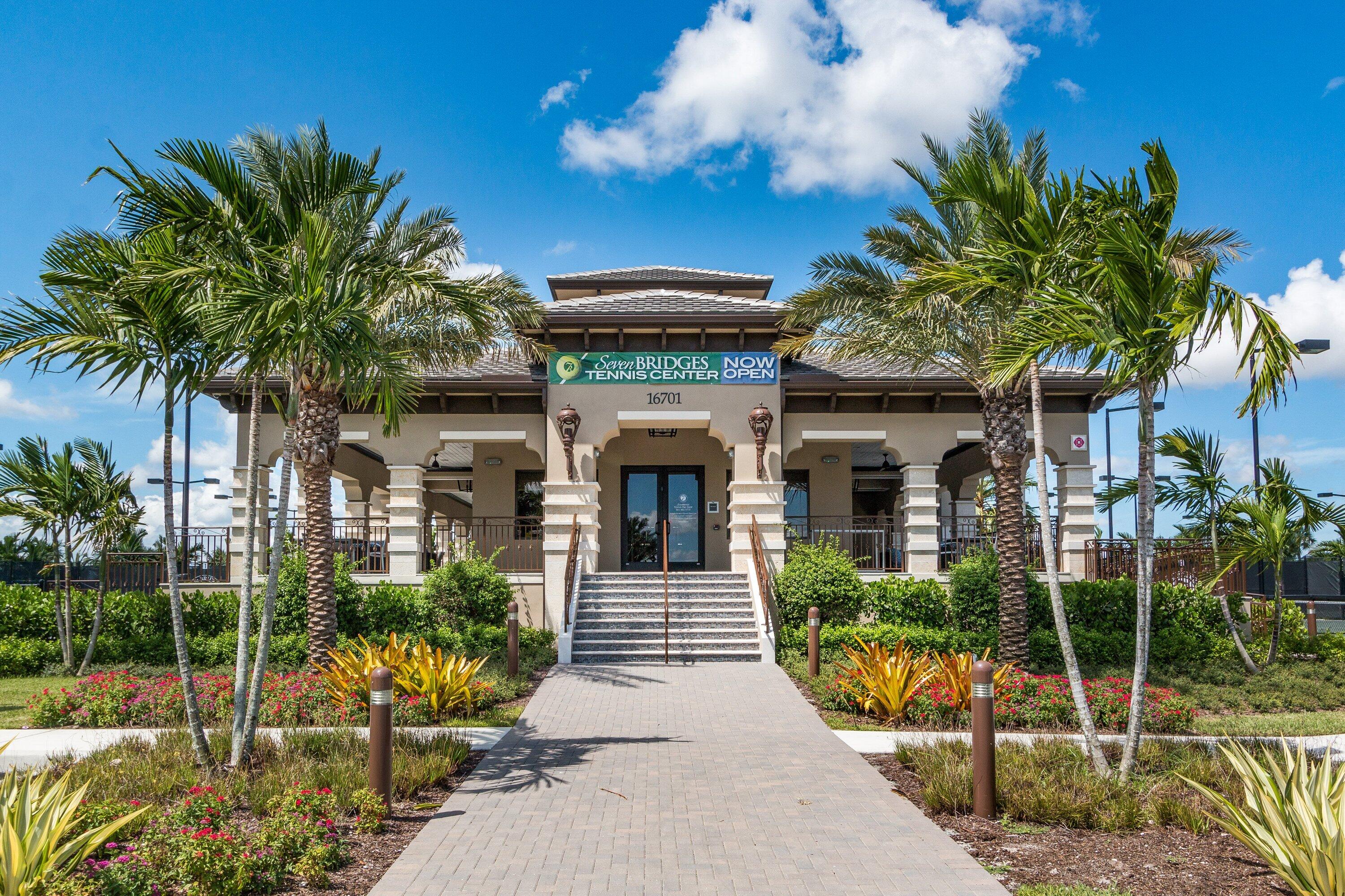 9349 Eden Roc Court Delray Beach, FL 33446 - Photo 43 of 50 a front view of a house with a garden