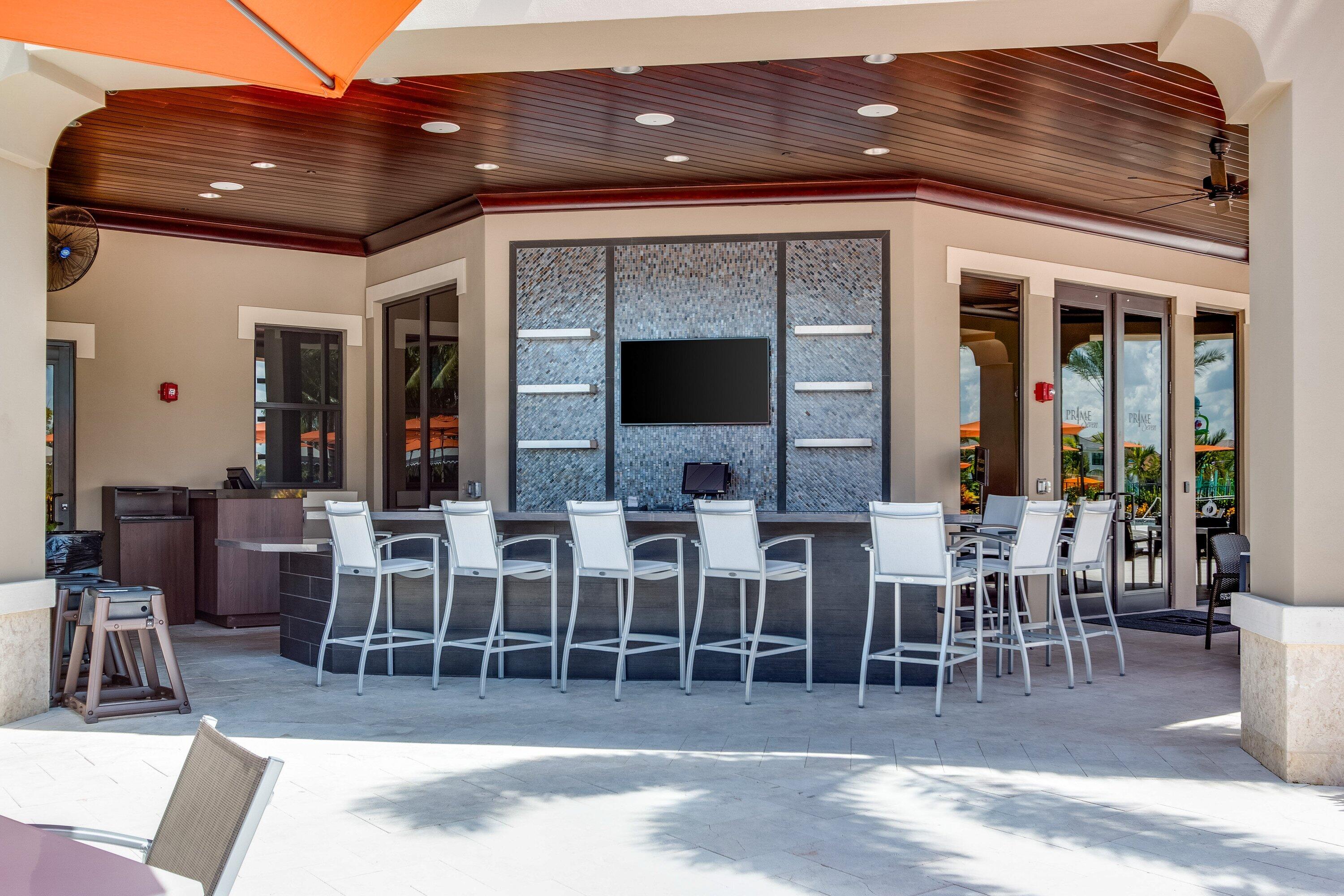 9349 Eden Roc Court Delray Beach, FL 33446 - Photo 44 of 50 a view of a patio with dining table and chairs