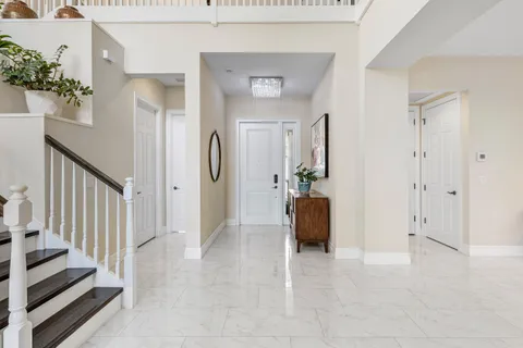 a view of a hallway view with wooden floor and staircase