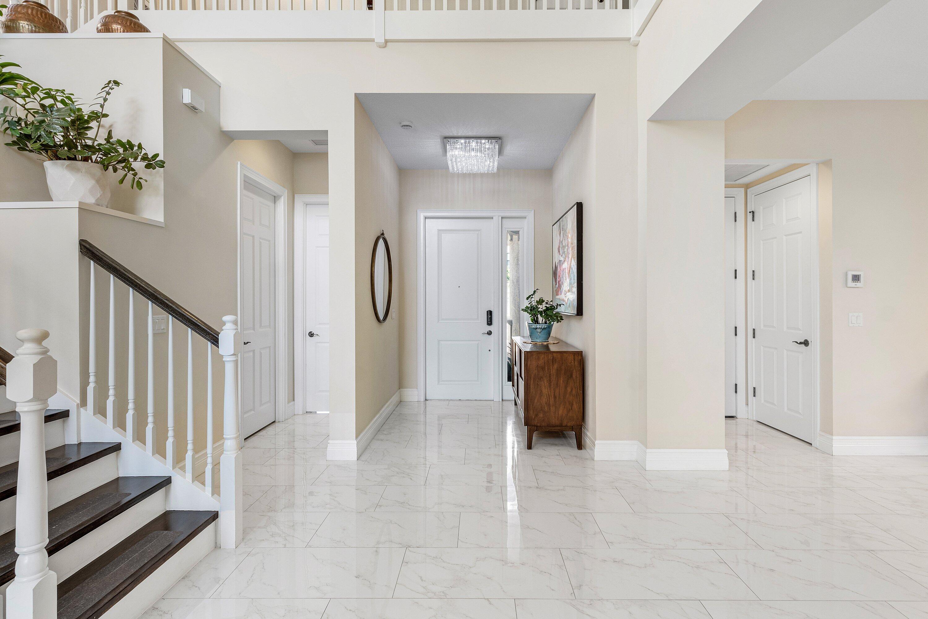 9349 Eden Roc Court Delray Beach, FL 33446 - Photo 5 of 50 a view of a hallway view with wooden floor and staircase