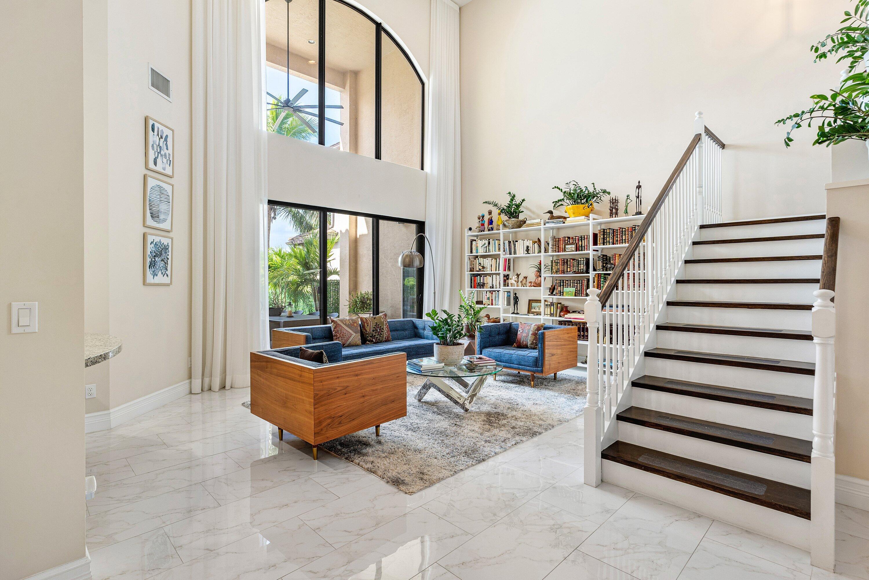 9349 Eden Roc Court Delray Beach, FL 33446 - Photo 6 of 50 a living room with furniture and stairs