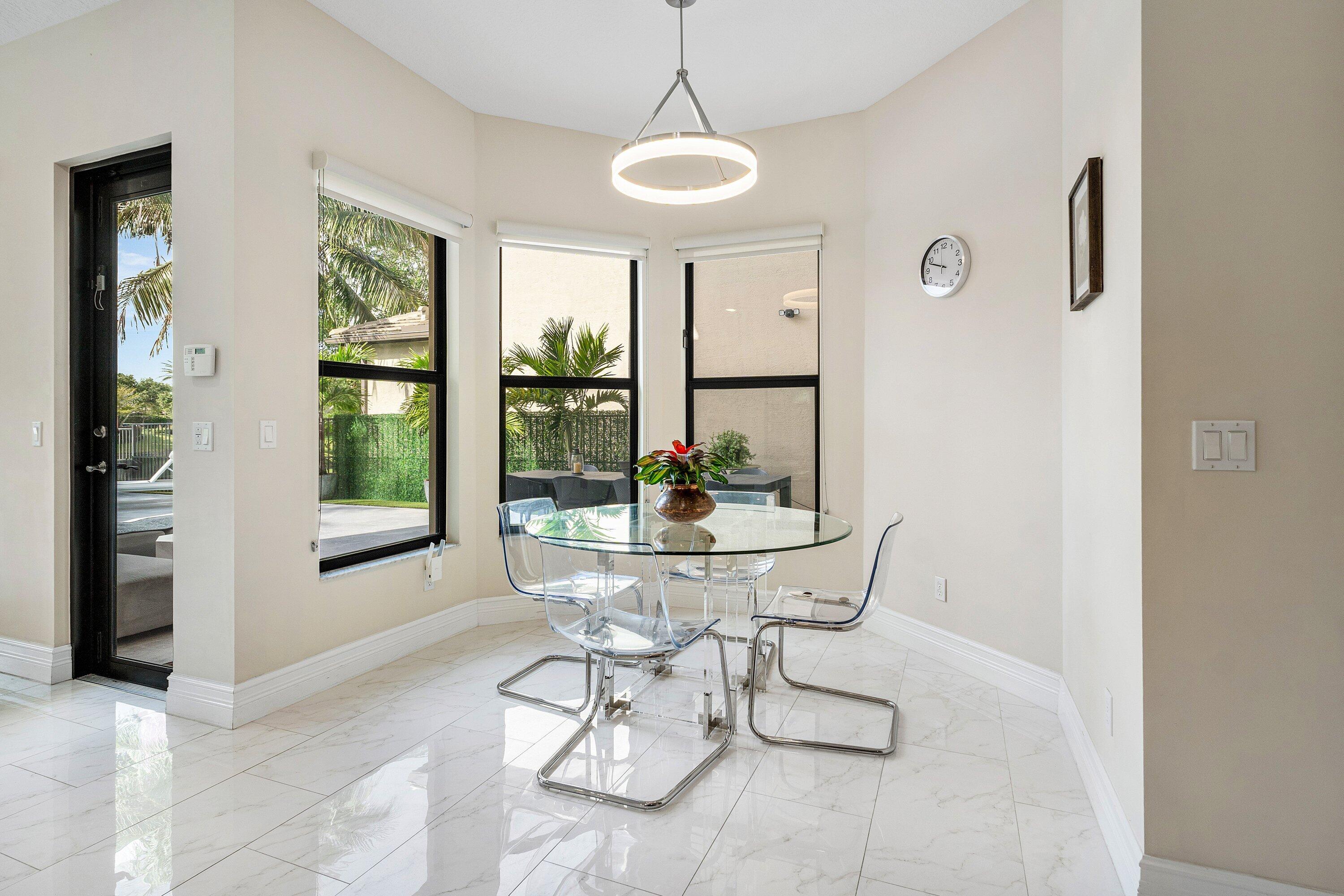 9349 Eden Roc Court Delray Beach, FL 33446 - Photo 10 of 50 a dining room with furniture and window
