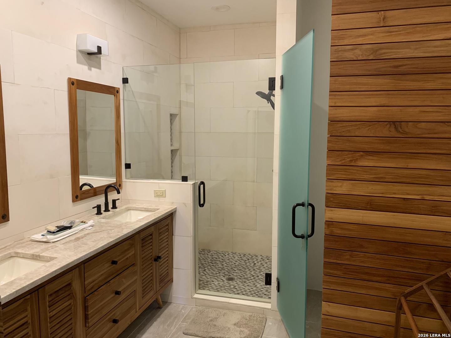 Undisclosed Address Fair Oaks Ranch, TX 78015 - Photo 4 of 12 a bathroom with a shower sink and mirror