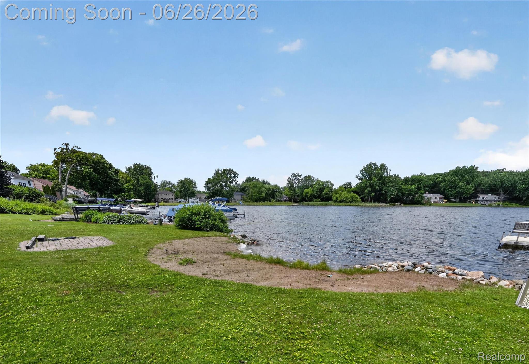 3478 Lexington Road Waterford, MI 48328 - Photo 33 of 52 Waterfront property featuring a grassy lawn, sand beach area, stone-lined shore, and a private boat dock