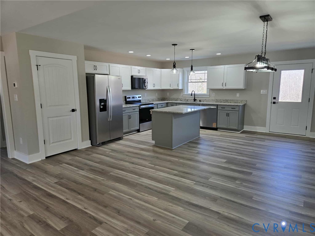 1781 Bumpass Road Bumpass, VA 23024 - Photo 12 of 26 a large kitchen with stainless steel appliances granite countertop a stove and a refrigerator
