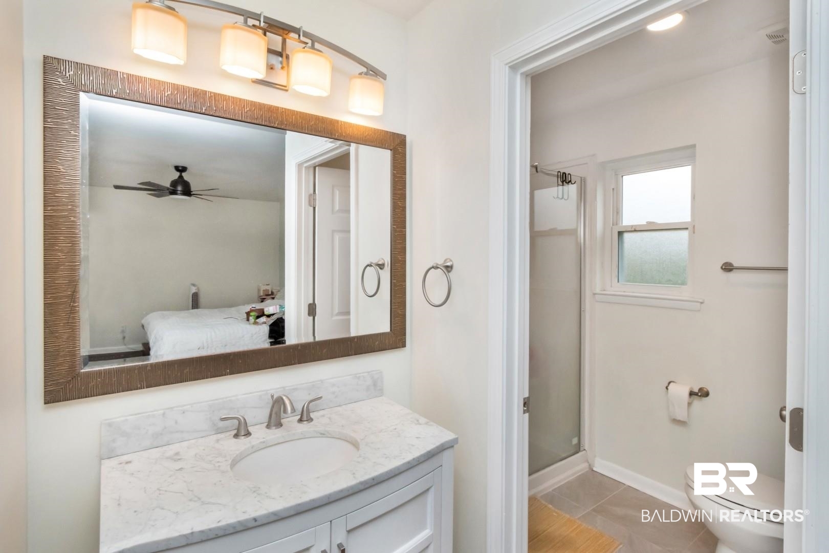 6208 Cottage Hill Road Mobile, AL 36609 - Photo 12 of 20 Ensuite bathroom featuring a shower stall, vanity, a ceiling fan, and light tile patterned flooring