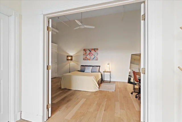 a spacious bedroom with a bed and a table