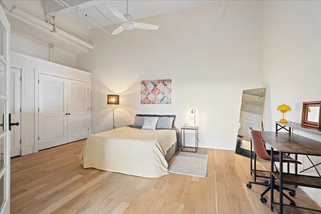 a spacious bedroom with a bed and a cabinets