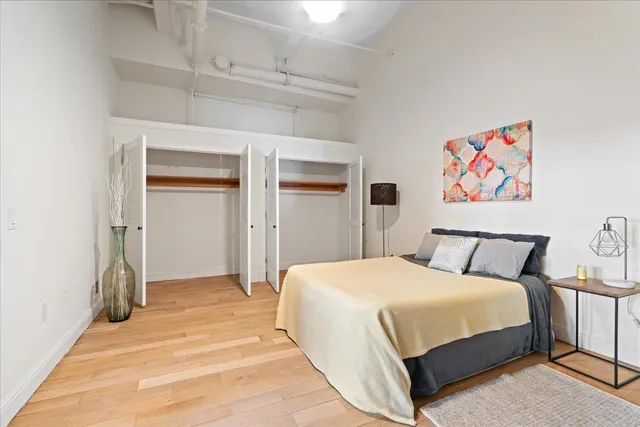 a bedroom with a bed a table and a book shelf
